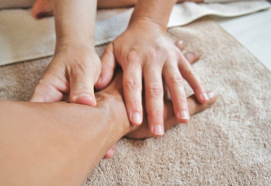 Eine Hand wird mit Physiotherapie behandelt